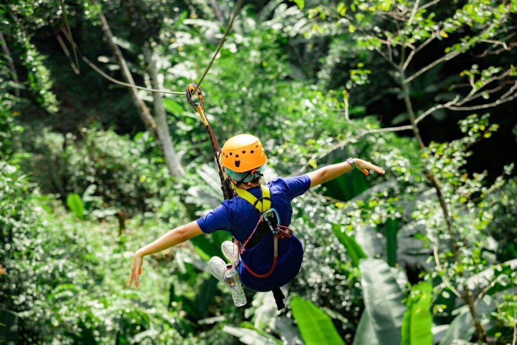 girl zip-lining in the jungle
