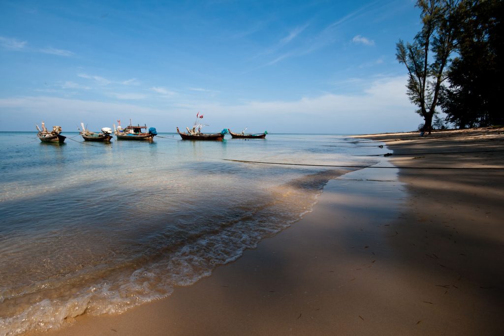 Boats in the shallows of Nai Yang Beach Thailand
